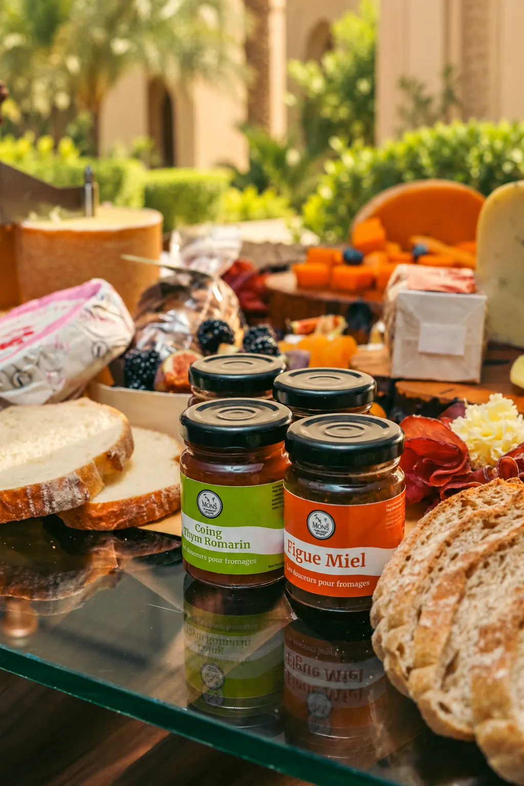 Jars of jam and fig honey with sliced bread