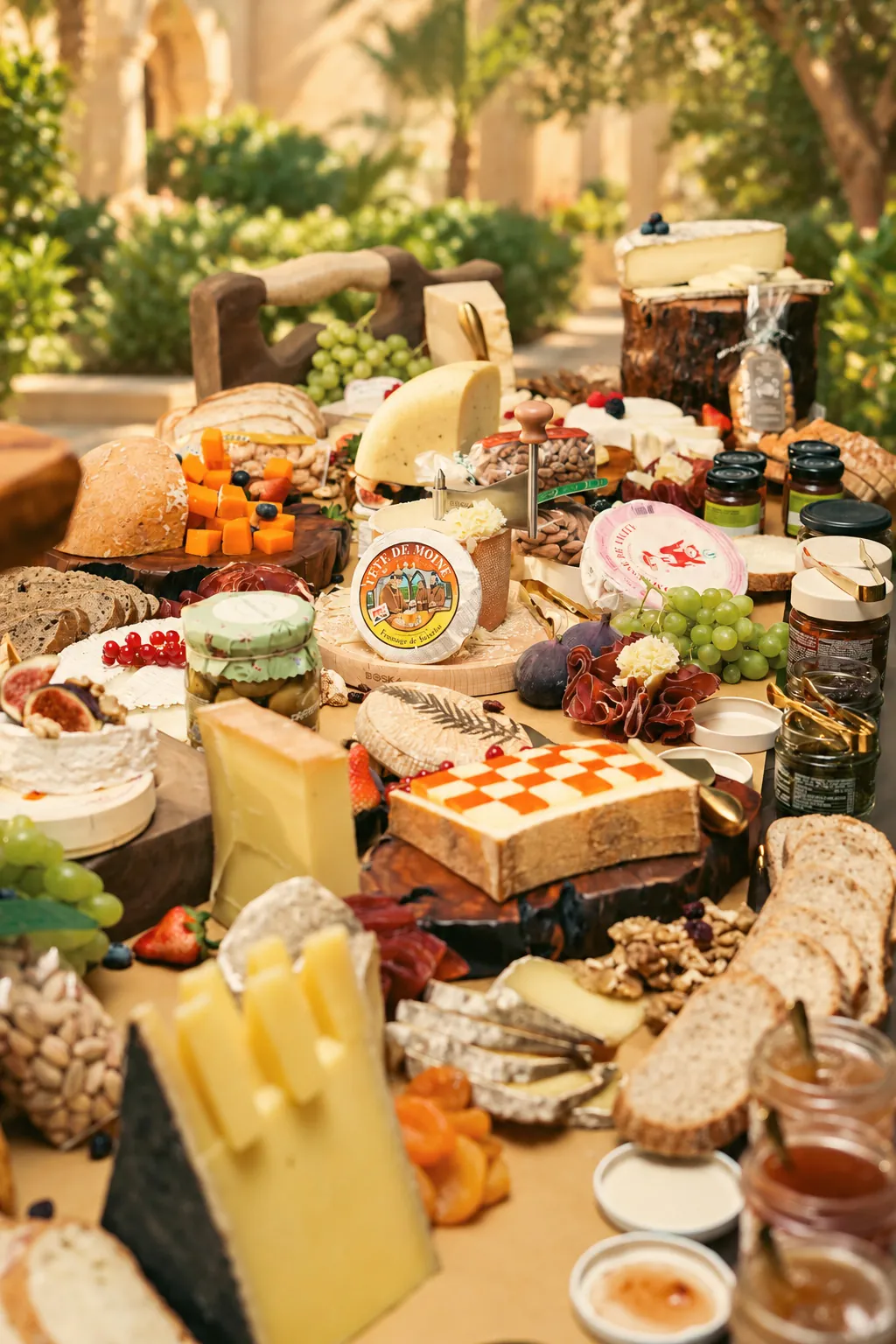 Cheeses and preserves arranged at the end of the grazing table